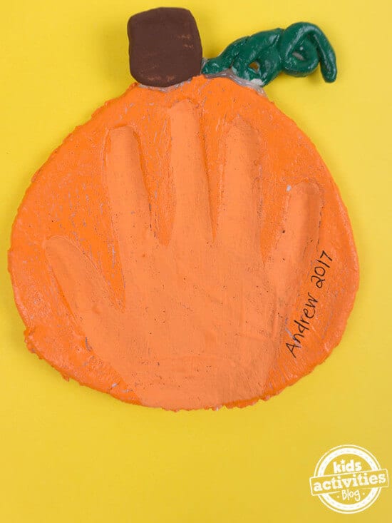 handprint craft for kids featuring pumpkin salt dough