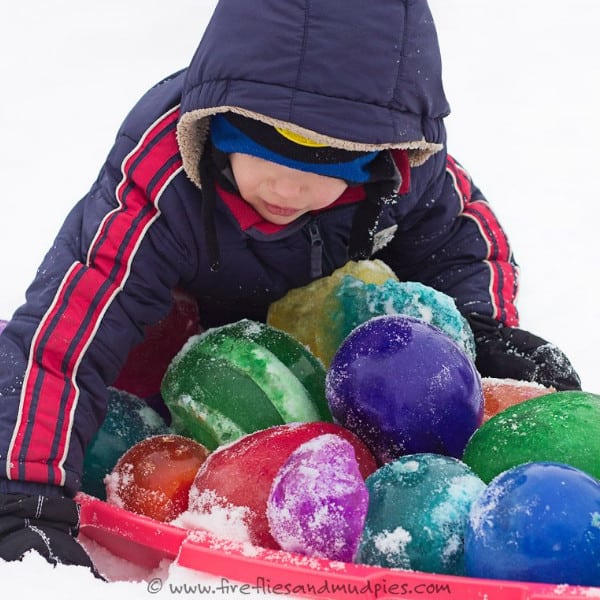 nopin="nopin" child playing with winter ice jewels in the snow