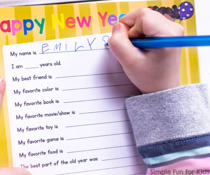 child's hand filling new year's survery activity