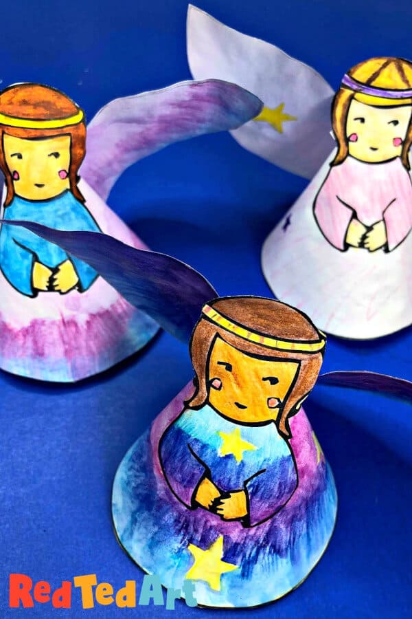 nopin="nopin" paper angels craft made with printable on a blue backdrop