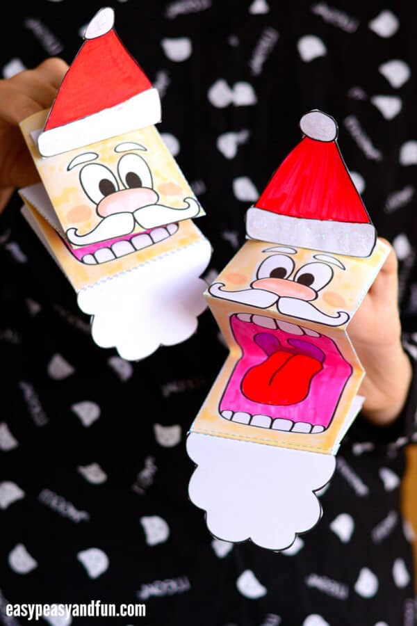 nopin="nopin" hand santa paper puppets in a black backdrop
